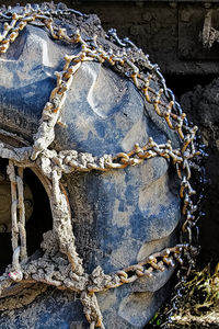 Close-up of old rusty chain against building