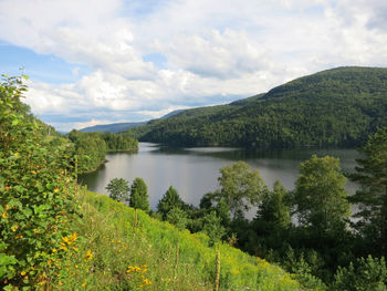 Scenic view of lake and mountains against sky