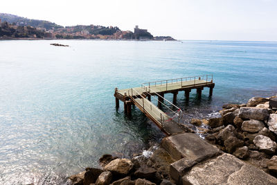 High angle view of pier over river on sunny day