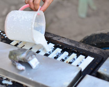 Midsection of person playing with ice cream