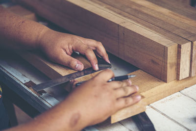 Midsection of man working on table