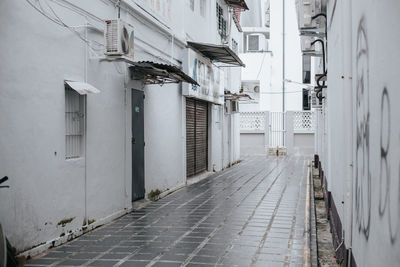 Empty alley amidst buildings in city