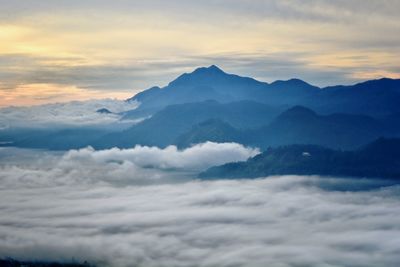 Scenic view of majestic mountains against sky during sunset