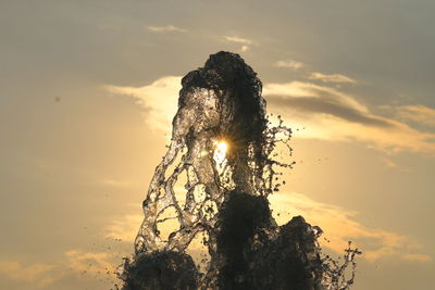 Low angle view of trees against sky at sunset