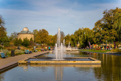 Fountain in lake against sky