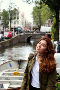 Young woman in boat on canal