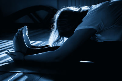 Young woman sitting on sofa at home