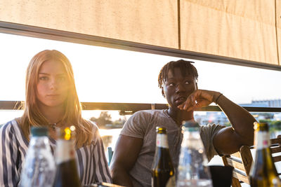 Portrait of an engaged multiethnic couple on summer vacation on a river cruise ship