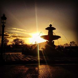 Fountain against sky during sunset