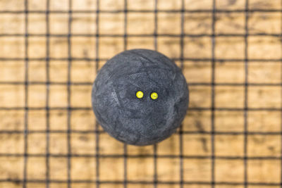Close-up of squash ball on racket