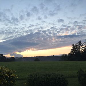 Scenic view of landscape against cloudy sky