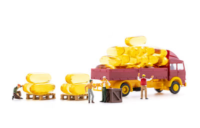 Close-up of yellow toy car against white background