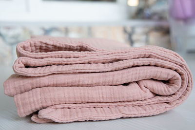 Soft muslin baby blanket. cotton textiles. natural organic fabrics texture. light pink rose color. 
