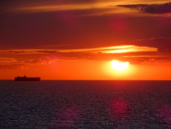 Scenic view of sea against orange sky