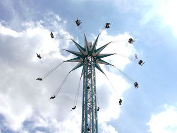 Low angle view of chain swing ride against sky