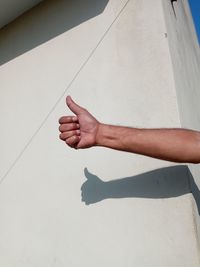 High angle view of person hand on tiled floor