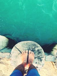 Low section of man standing in swimming pool