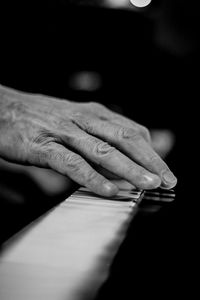 Close-up of man playing piano