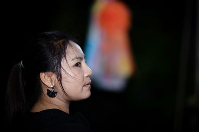 Close-up portrait of woman looking away outdoors