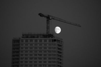 Low angle view of building against sky at moonnight