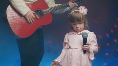 Portrait of girl playing guitar