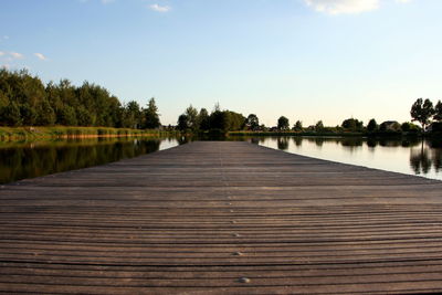 Pier over lake against sky