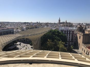 Buildings in city against clear sky