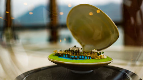 Close-up of lemon slice in plate on table