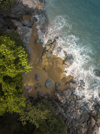 High angle view of rocks by sea