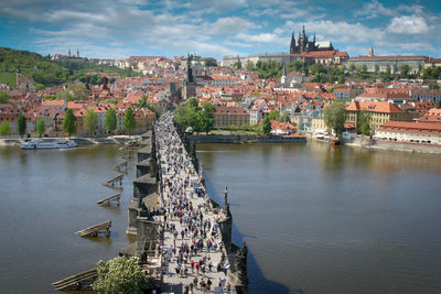 High angle view of crowds walking on bridge over vltava river