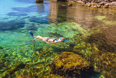 High angle view of man swimming in sea