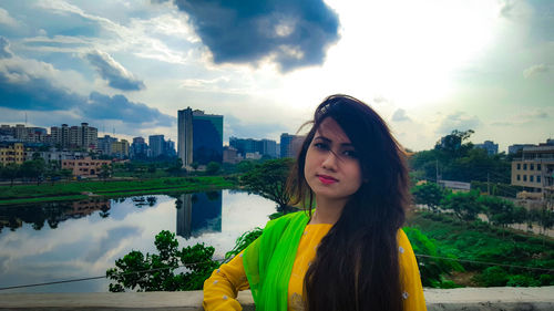 Beautiful woman standing against city