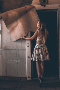 Woman standing against wall