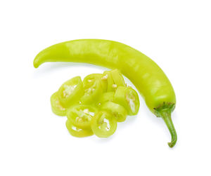 Close-up of green chili pepper against white background