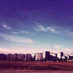 View of cityscape against blue sky