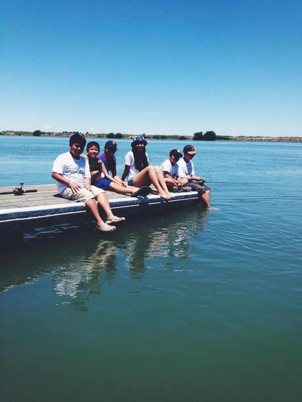 water, clear sky, lifestyles, leisure activity, copy space, togetherness, men, sea, person, blue, vacations, nautical vessel, enjoyment, waterfront, nature, friendship, bonding, sitting