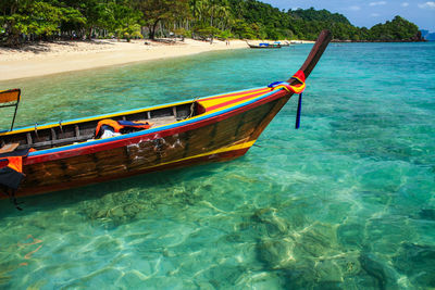 Boat moored on sea shore