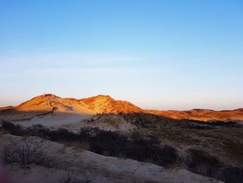 Scenic view of arid landscape against sky