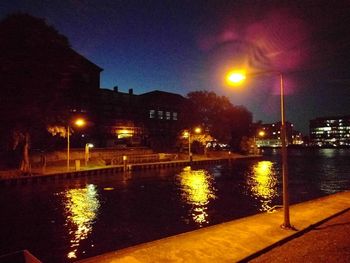 Illuminated city street at night