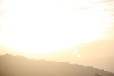 Scenic view of silhouette mountains against sky during sunrise