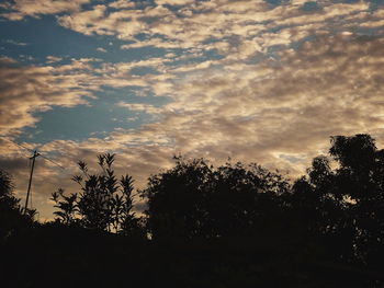 Low angle view of silhouette trees against sky at sunset