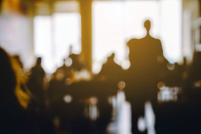 Defocused image of silhouette people at illuminated nightclub