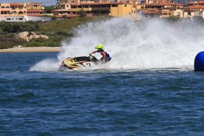 Man riding motor boat in sea