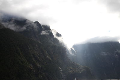 Scenic view of mountains against cloudy sky