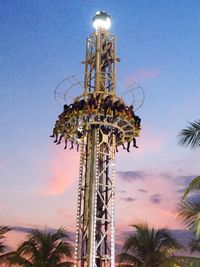 Low angle view of amusement park ride against sky