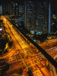 High angle view of illuminated city street and buildings at night