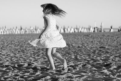 Full length of a girl standing on beach