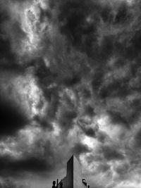 Low angle view of building against cloudy sky