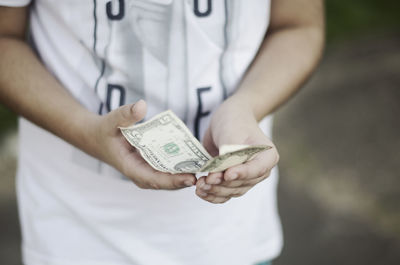 Midsection of a man holding camera