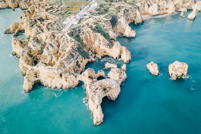 High angle view of rock formations at seaside